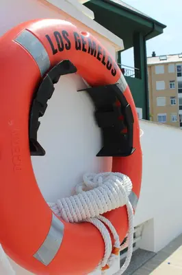 a life saving ring on the side of a life preserver at Apartamentos Los Gemelos in Foz