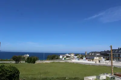 a view of the ocean from a house at Apartamentos Los Gemelos in Foz