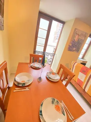 a dining room table with plates and utensils on it at S&H La Marimorena in Ribadeo