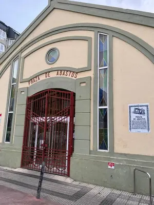 a building with a red gate in front of it at S&H La Marimorena in Ribadeo