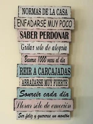a group of signs hanging on a wall at S&H La Marimorena in Ribadeo