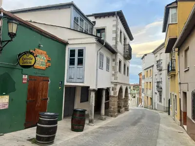 an empty street in a city with buildings at S&H La Marimorena in Ribadeo