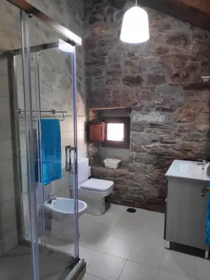 a bathroom with a toilet and a sink and a shower at Apartamentos C'Ambrosio in La Peral
