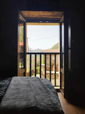 a bedroom with a bed and a large window at Apartamentos C'Ambrosio in La Peral