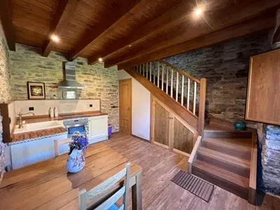 a kitchen with a sink and a staircase in a house at Casa rural LA TORRE recién rehabilitada. in Las Herrerías