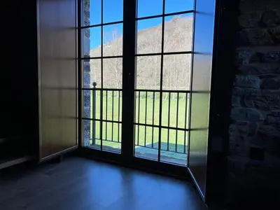an open door to a room with a view of a building at Casa rural LA TORRE recién rehabilitada. in Las Herrerías