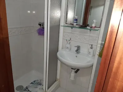 a bathroom with a sink and a shower at Alquiler de apartamento en el centro de Viveiro in Viveiro