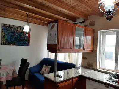 a kitchen with a blue chair and a blue couch at Alquiler de apartamento en el centro de Viveiro in Viveiro