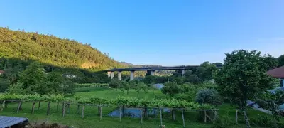 a bridge over a river next to a mountain at A Taberna de Gundián in Vedra