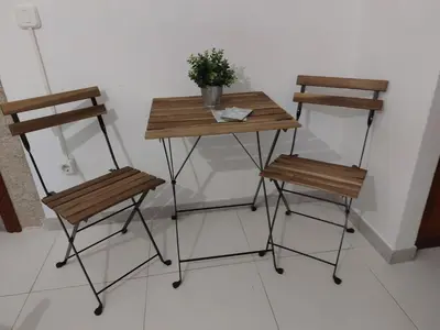 a table and two chairs with a plant on it at A Taberna de Gundián in Vedra