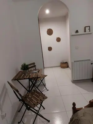 a living room with chairs and a wall withartifacts at A Taberna de Gundián in Vedra