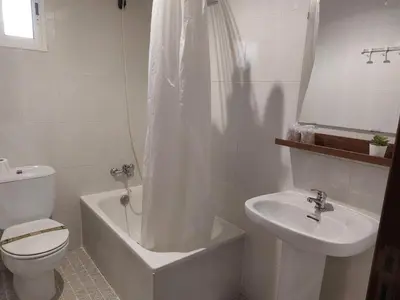 a bathroom with a toilet and a tub and a sink at A Taberna de Gundián in Vedra