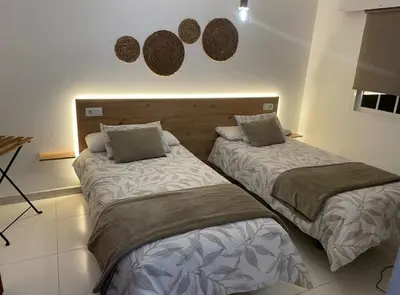 two beds sitting next to each other in a room at A Taberna de Gundián in Vedra