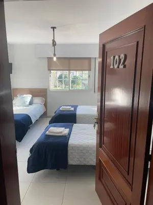 a room with two beds and a door with the number at A Taberna de Gundián in Vedra