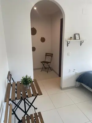 a room with a bed and a chair and a table at A Taberna de Gundián in Vedra