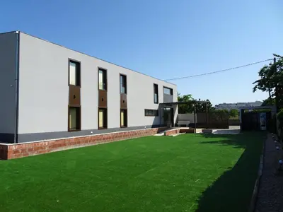 a building with a lawn in front of it at Albergue Santiago 15 Monforte in Monforte de Lemos