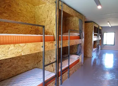 a room with a bunch of bunk beds at Albergue Santiago 15 Monforte in Monforte de Lemos