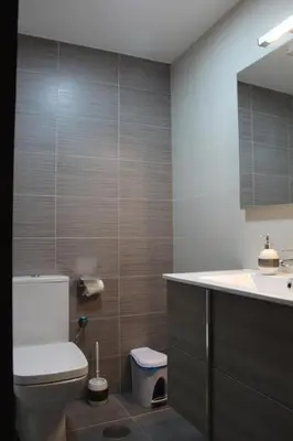 a bathroom with a toilet and a sink and a mirror at Hotel Rego Foz in Foz