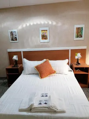 a bedroom with a large white bed with two night stands at Cuatro Caminos in Sarria