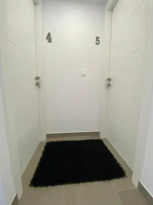 a room with two doors and a black rug at A Casa do Lado in Melide