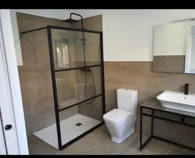 a bathroom with a shower and a toilet and a sink at A Casa do Lado in Melide