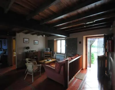 a living room with a couch and a table at Apartamentos Rurales Romallande in Puerto de Vega
