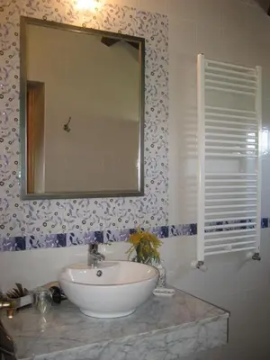 a bathroom with a sink and a mirror at Apartamentos Rurales Romallande in Puerto de Vega