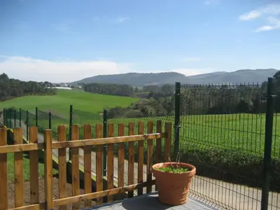 a porch with a fence and a potted plant at Apartamentos Rurales Romallande in Puerto de Vega