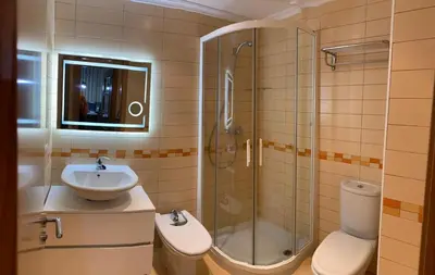 a bathroom with a sink and a shower and a toilet at A&M Burela Costa in Burela de Cabo