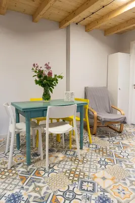 a dining room with a table and chairs on a mosaic floor at Casa Doade, en A Ribeira Sacra in Doade