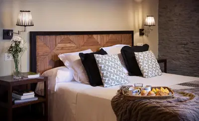 a hotel room with a bed with a tray of food on it at Hotel Pleamar in Puerto de Vega