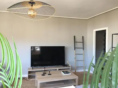 a living room with a flat screen tv on a wall at ***NUEVO Piso en Ourense WIFI Parking*** in Ourense