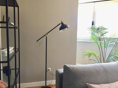 a floor lamp in a living room next to a couch at ***NUEVO Piso en Ourense WIFI Parking*** in Ourense