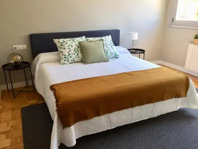 a bedroom with a bed with pillows on it at ***NUEVO Piso en Ourense WIFI Parking*** in Ourense