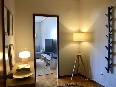 a mirror in a room with a lamp and a couch at ***NUEVO Piso en Ourense WIFI Parking*** in Ourense