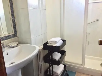 a bathroom with a sink and a bath tub and a towel rack at ***NUEVO Piso en Ourense WIFI Parking*** in Ourense