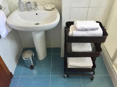 a bathroom with a sink and a towel rack next to a sink at ***NUEVO Piso en Ourense WIFI Parking*** in Ourense