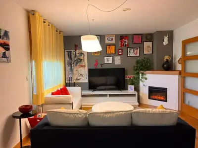 a living room with a couch and a tv at Casa JyM Fontela 24 in O Pedrouzo