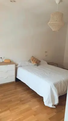 a bedroom with a white bed and a dresser at Casa JyM Fontela 24 in O Pedrouzo