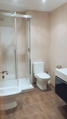 a bathroom with a toilet and a shower and a sink at Casa JyM Fontela 24 in O Pedrouzo