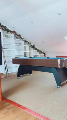 a ping pong table in the middle of a room at Casa JyM Fontela 24 in O Pedrouzo