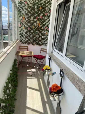 a patio with two chairs and a table on a balcony at Apartamento Centro Frente Muralla 2 in Lugo