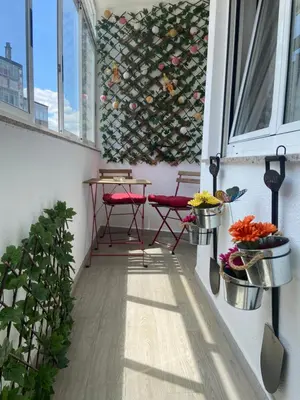 a balcony with two chairs and a table and a window at Apartamento Centro Frente Muralla 2 in Lugo