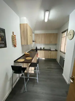 a kitchen with a table and chairs in a room at Precioso piso en el centro de Galicia. in Silleda