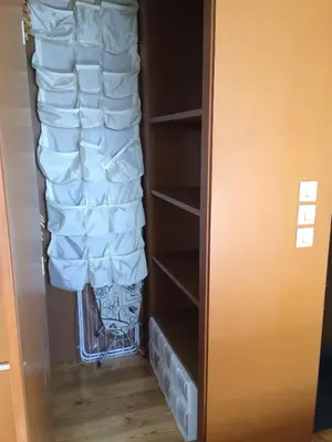 a closet filled with lots of white towels at Attic loft to wake up by the sea. in Sada