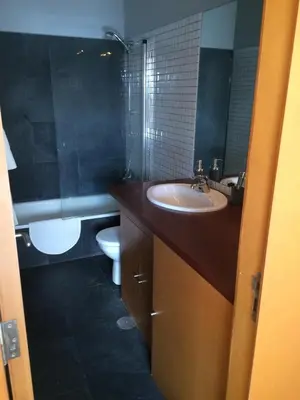 a bathroom with a sink and a toilet at Attic loft to wake up by the sea. in Sada