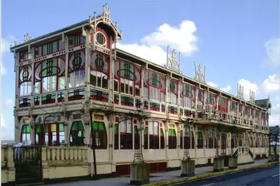 a large white building with a lot of windows at Attic loft to wake up by the sea. in Sada