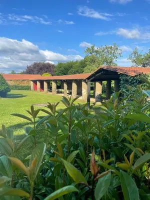 a garden with a pavilion in the background at Aldea A Paínza in Arzúa