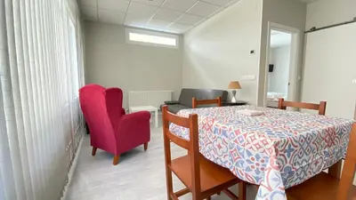 a dining room with a table and two chairs at Apartamentos Pantón Ribeira Sacra in Ferreira de Panton