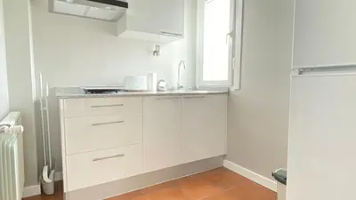 a white kitchen with a sink and a window at Apartamentos Pantón Ribeira Sacra in Ferreira de Panton